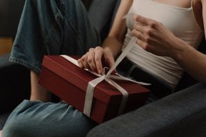 Young adult unwrapping a birthday present